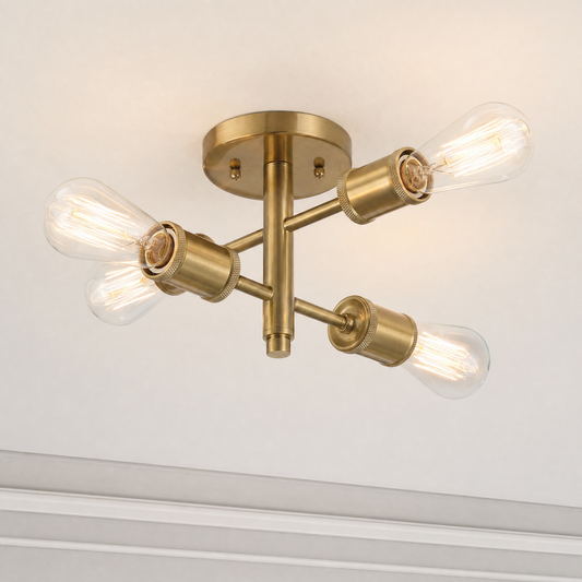 Antique brass four-light semi-flush ceiling light with illuminated clear bulbs, close-up